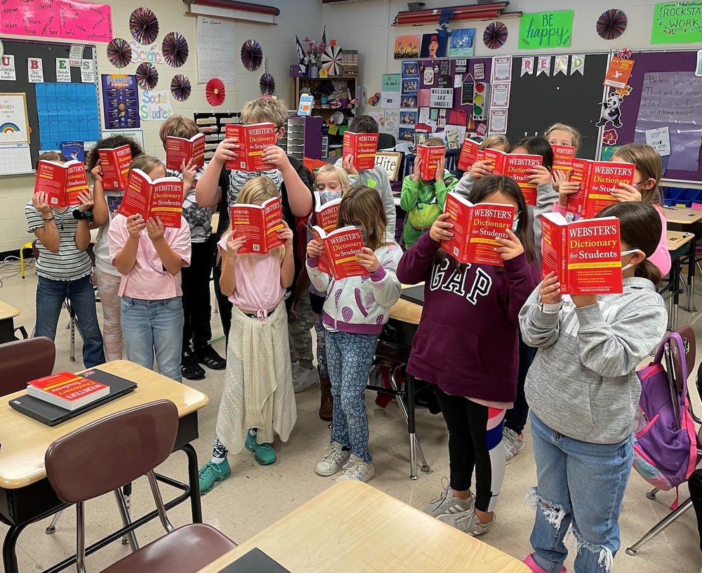 Students holding dictionaries