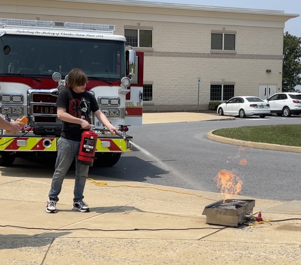 Student using fire extinguisher