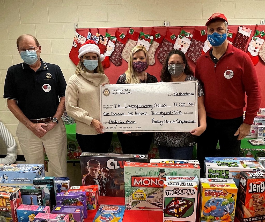  from left to right, Rotary Club member Walt Eifert; Rotary Club Youth Service Committee Chair Cara Keys; T.A. Lowrey Principal Kristen Martin; T.A. Lowery Special Education Teacher Beth Saunders, who helps direct the toy drive; and Rotary Club President Steve Campbell.
