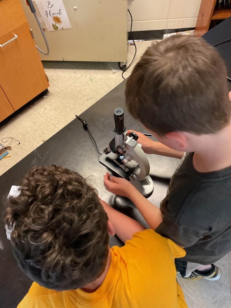 student with microscope
