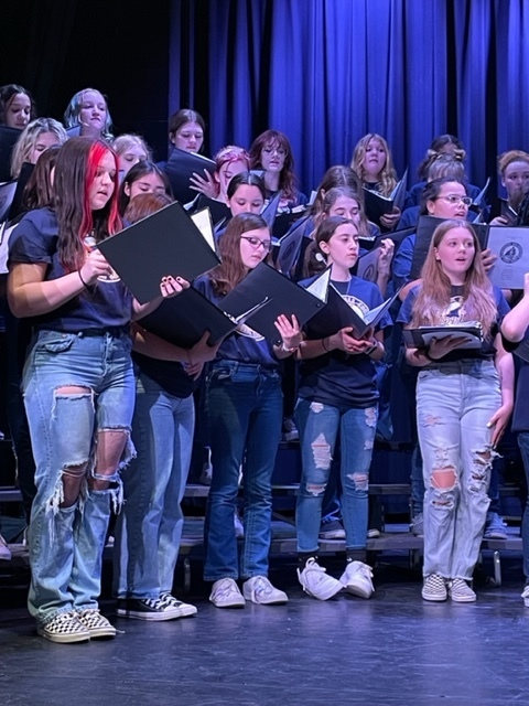 Middle School All-County Honors Choir performing on stage