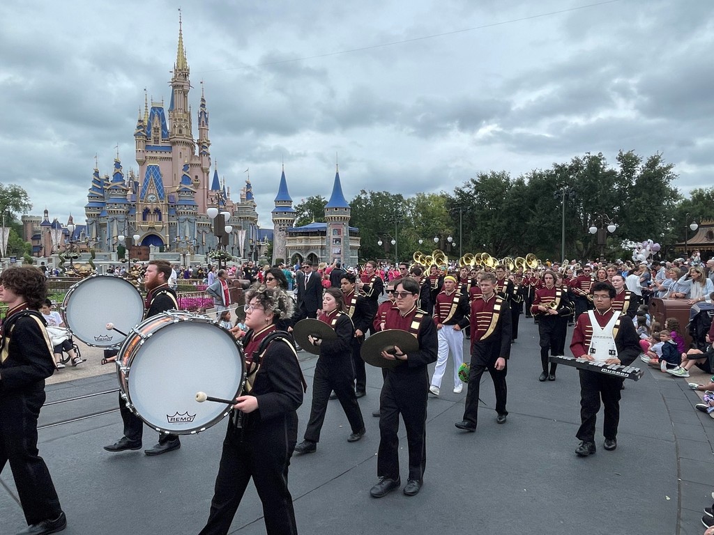 JHS Marching Band performing at Disney World with Disney castle in background