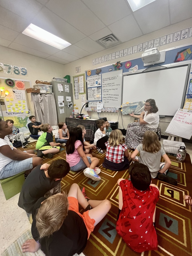 Teacher reading to a classroom of students
