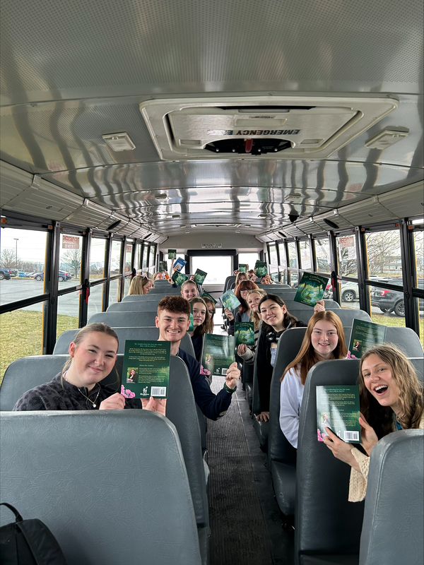Key Club on bus going to read to SJE students